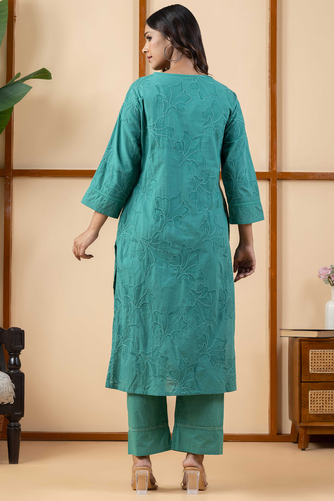Back profile view showing the regular fit drape of the green cotton kurta and matching pants