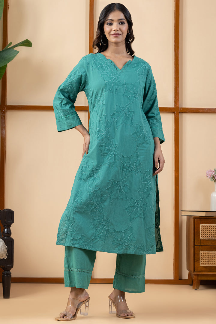 Front view of a woman wearing a pure cotton kurta set for women in green with V-neck embroidery in regular and plus sizes